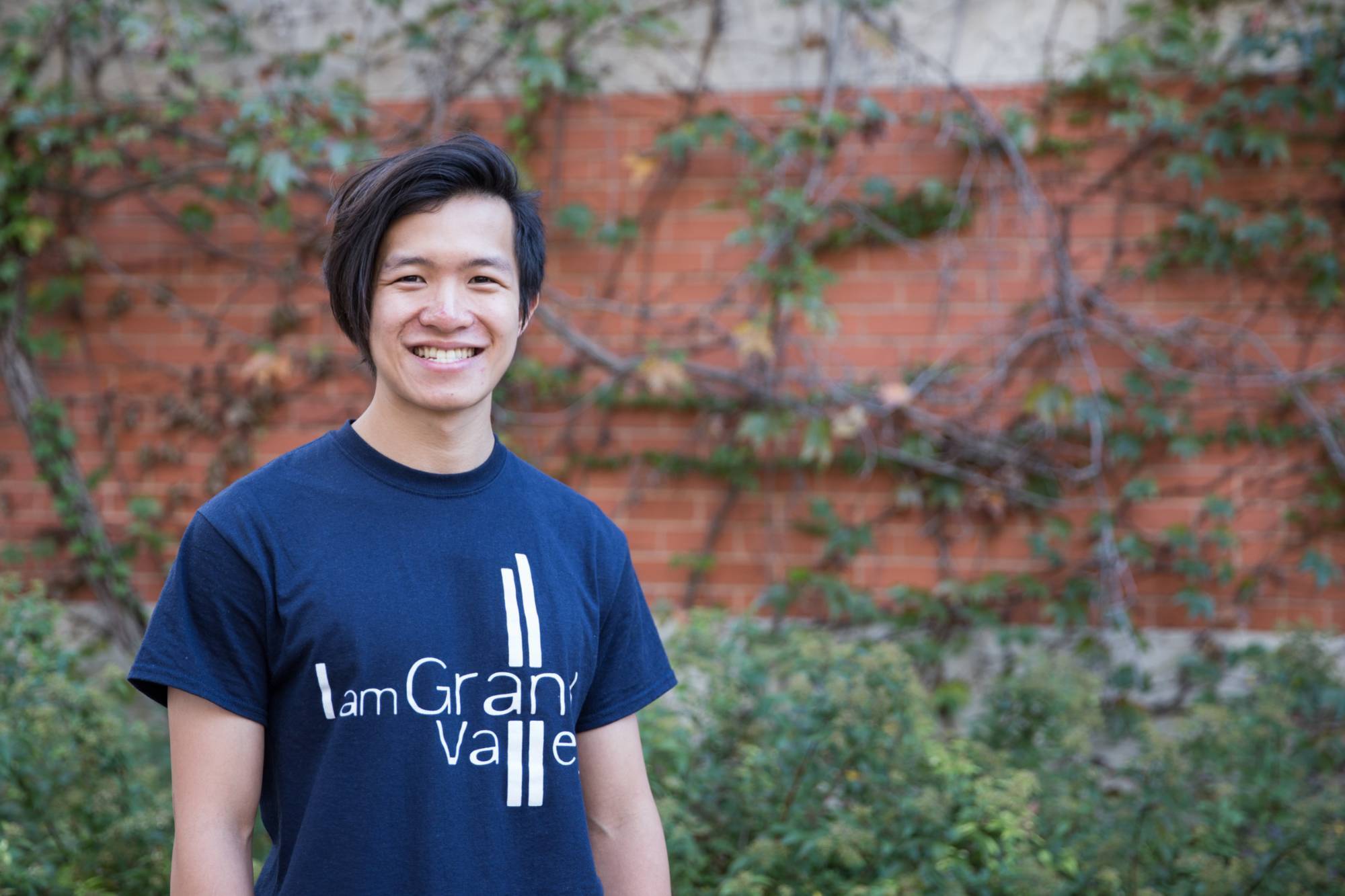 "I am Grand Valley" student recipient head-shot in front of a brick wall